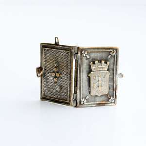 Antique miniature metal book with the coat of arms of the city of Antwerp