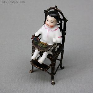 antique metal high chair seated all-bisque doll , antique porcelain doll , antique Seated frozen charlotte 