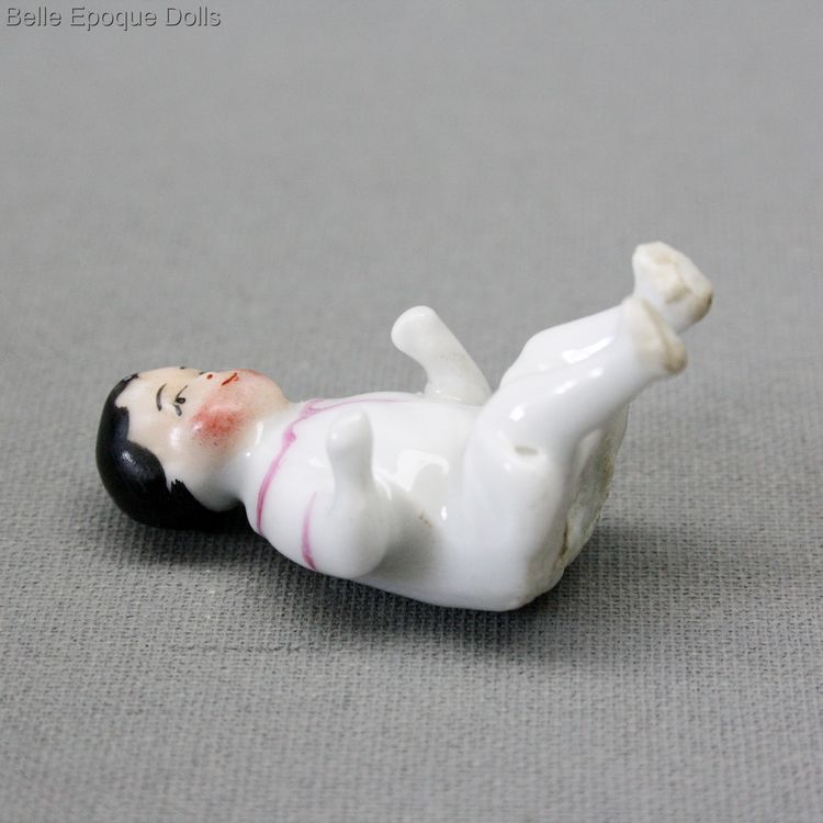 antique porcelain doll , antique metal high chair seated all-bisque doll , antique Seated frozen charlotte