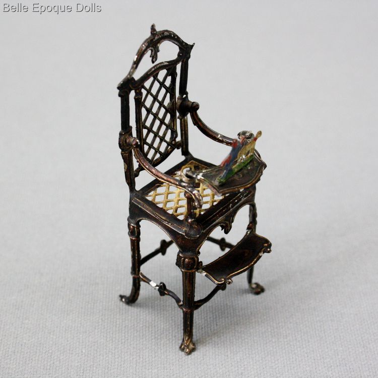 antique metal high chair seated all-bisque doll , antique porcelain doll